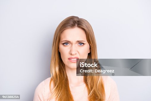 istock Close up portrait of funny confused puzzled unhappy upset sad uncertain unsure beautiful pretty charming grimacing woman with long blonde hairdo isolated on gray background opy-space 961388254