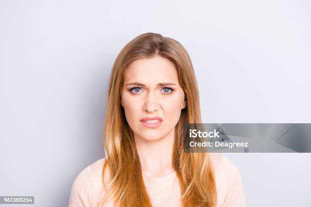 Close Up Portrait Of Funny Confused Puzzled Unhappy Upset Sad Uncertain Unsure Beautiful Pretty Charming Grimacing Woman With Long Blonde Hairdo Isolated On Gray Background Opyspace Stock Photo - Download Image Now