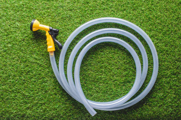 istock top view of hosepipe on green grass, minimalistic conception 961389110