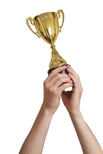 istock Raised hands of a man are holding trophy. Isolated on white 961398826