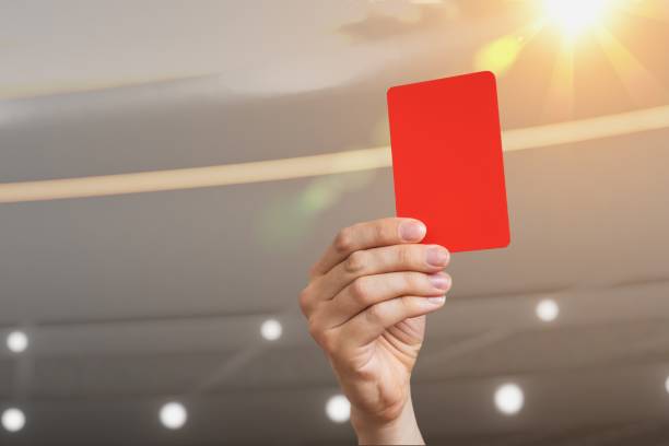 istock Close-up view on referee hand showing red card in soccer stadium. 961399320