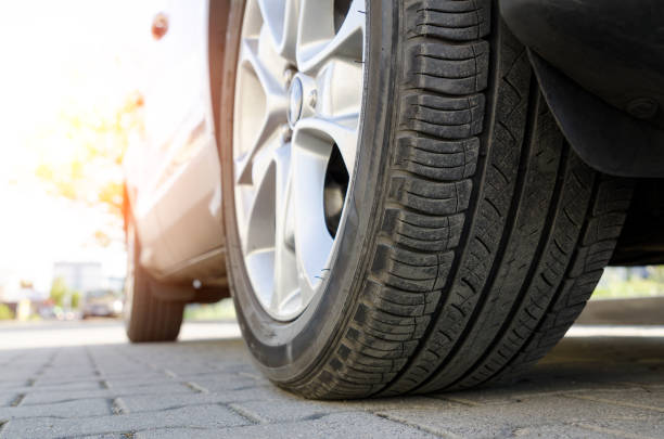 istock Car tire close up, parked car low angle shot 961399782