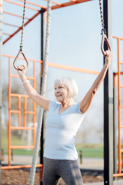 istock Happy old woman doing chin-ups 961399814