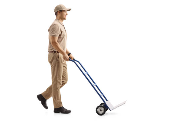 istock Delivery man pushing an empty hand truck 961399834