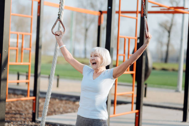 istock Content old woman doing chin-ups 961399890