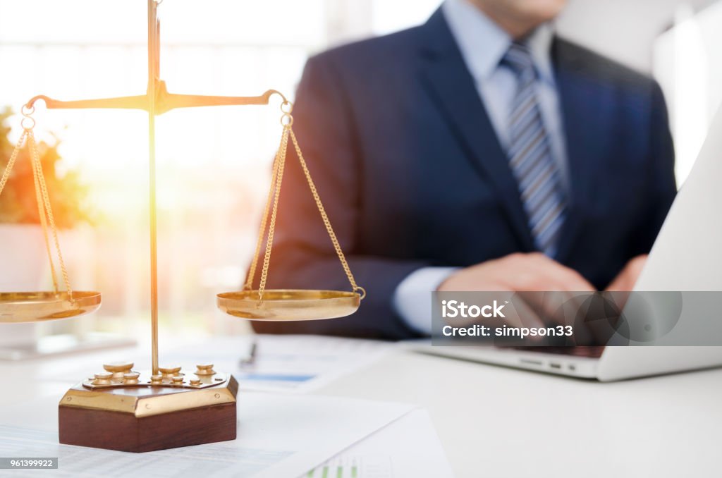 Justice symbol weight scales on table Justice symbol weight scales on table. Attorney working in office. Law attorney court judge justice legal legislation concept Lawyer Stock Photo