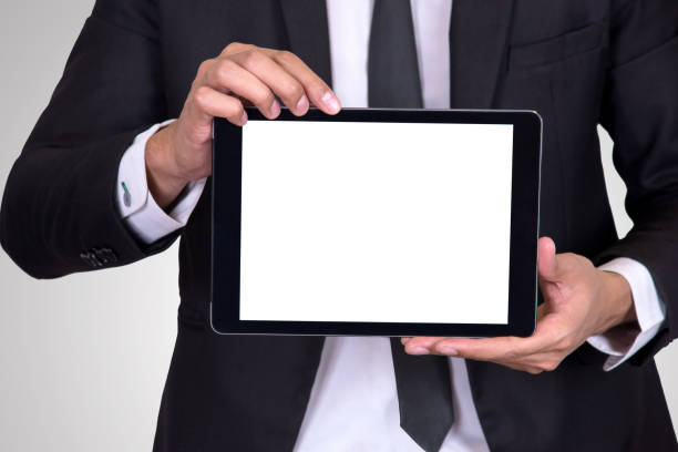 istock Businessman holding Digital tablet with blank screen on white background 961400374