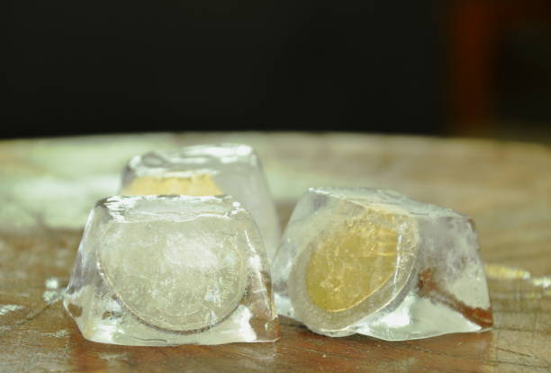 istock coin freezing in ice cube on wooden board 961401170