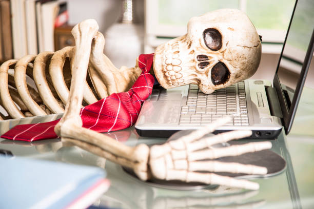 istock Skeleton businessman worked to death in office. 961403516
