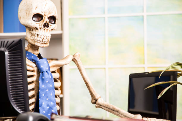 istock Skeleton businessman worked to death in office. 961404586