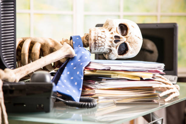 istock Skeleton businessman worked to death in office. 961405024