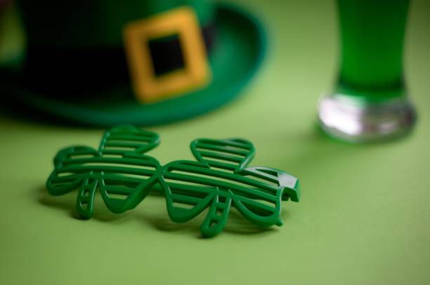 istock Close-Up Of Green Clover Shaped Sunglasses On Table 961406134