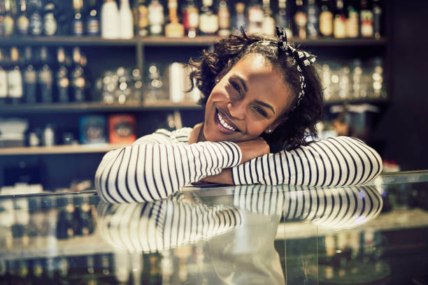 istock Smiling young African entrepreneur leaning on her cafe counter 961411110