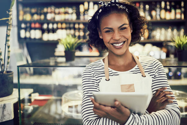 istock Smiling young African entrepreneur standing in her cafe 961411234
