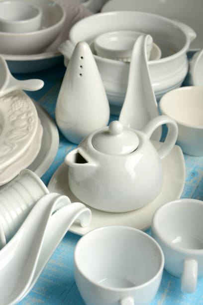 istock white porcelain kitchenware on light blue wooden table 961411600