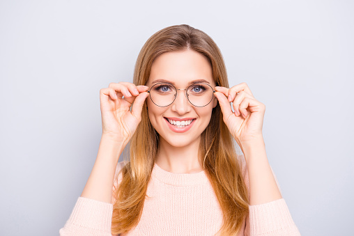 Try-on round old-fashioned people person concept. Close up portrait of cute charming gorgeous lovely clever confident pretty teen age girl touching thin rim-glasses isolated on gray background
