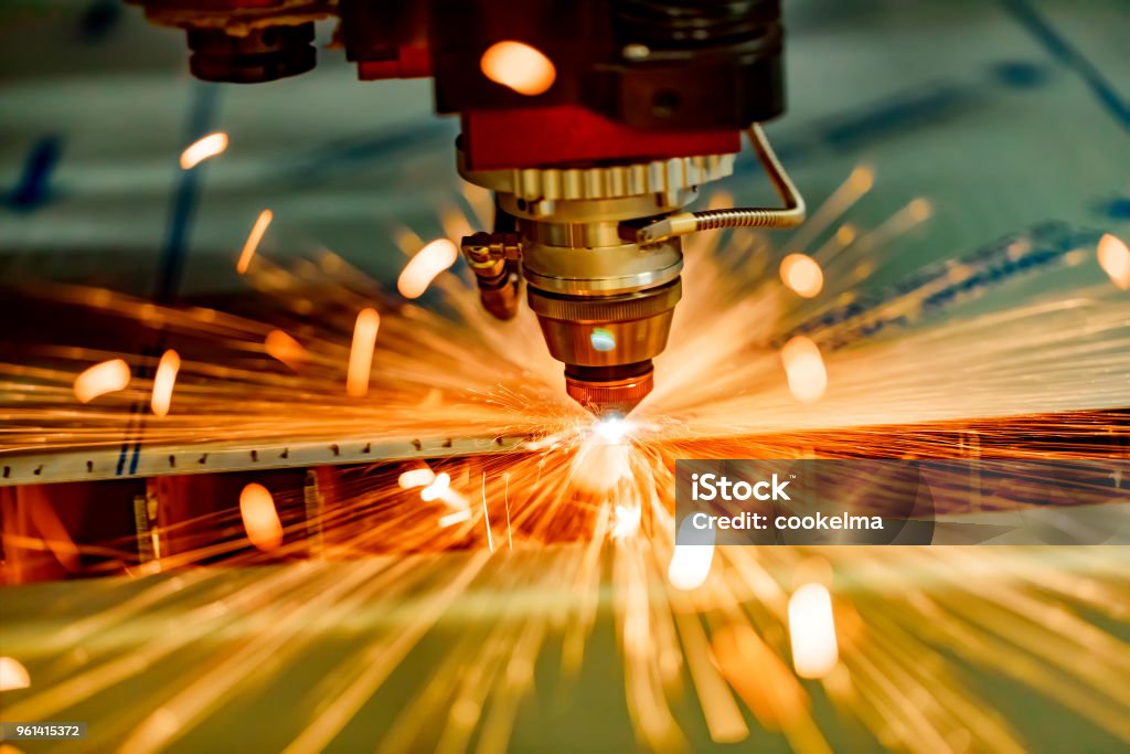 CNC Laser cutting of metal, modern industrial technology. CNC Laser cutting of metal, modern industrial technology. Small depth of field. Warning - authentic shooting in challenging conditions. Engraving Stock Photo