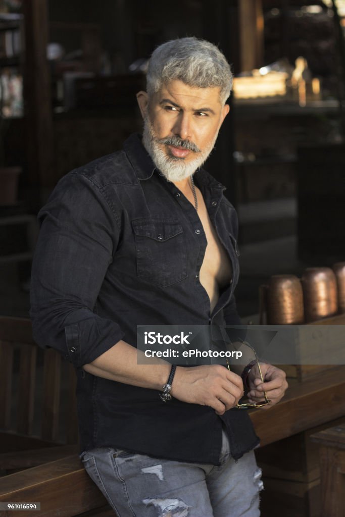Man With White Hair And Beard In Black Shirt Looking Sideways Stock Photo -  Download Image Now - iStock