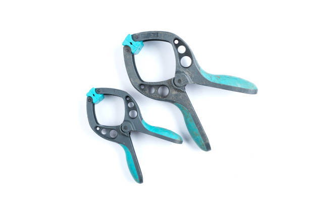 istock Set of green plastic spring clamps on a white background. Strong Industrial spring clamps. 961420828