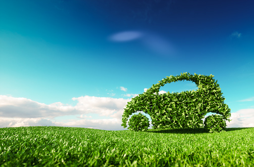 Eco friendly car development, clear ecology driving, no pollution and emmission transportation concept. 3d rendering of green car icon on fresh spring meadow with blue sky in background.