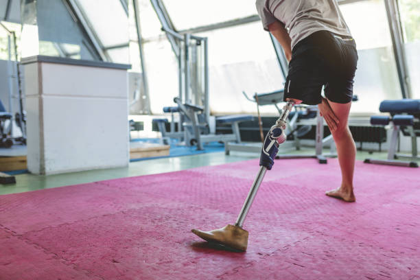 istock Young man with orthopedic leg stretching in the gym 961422456