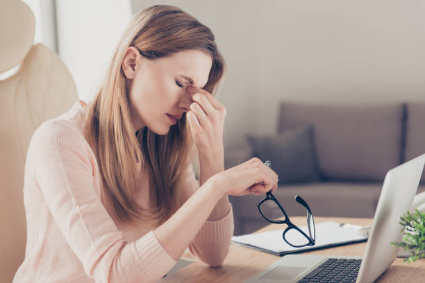istock Laptop computer modern technology boss cold flu people person concept. Profile side view portrait of sad unhappy tired frustrated disappointed lady suffering from migraine sitting at the table 961422798
