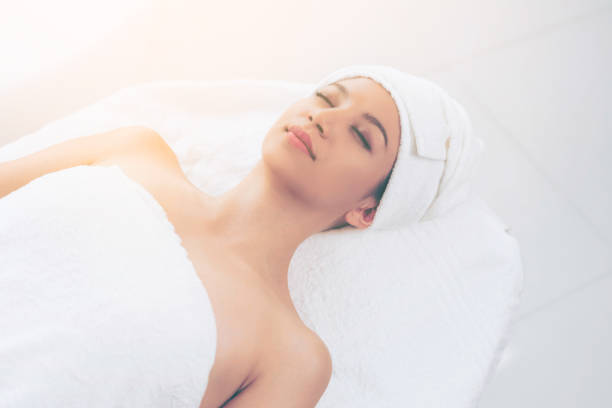istock Relaxed young woman lying on spa bed for massage. 961427566