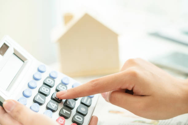 istock Woman accountant or bank worker uses calculator. 961428090