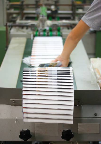 istock Stack Of Books With Worker Working At Production Line In Factory 961433126