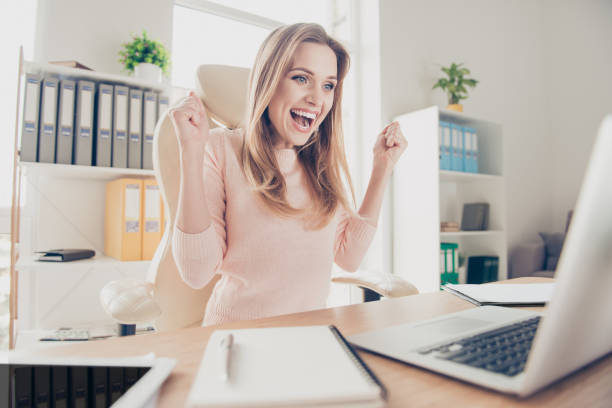 Progress effort benefit attainment advance prosperity people person breakthrough joy concept. Portrait of cheerful joyful excited lovely financier stockholder celebrating success in front of netbook