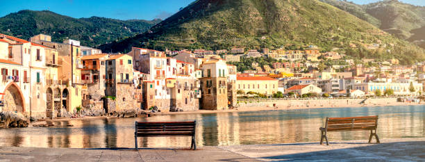 Cefalu Beach Photo of Cefalu beach. Tranquil scene with two benchs . cefalu stock pictures, royalty-free photos & images