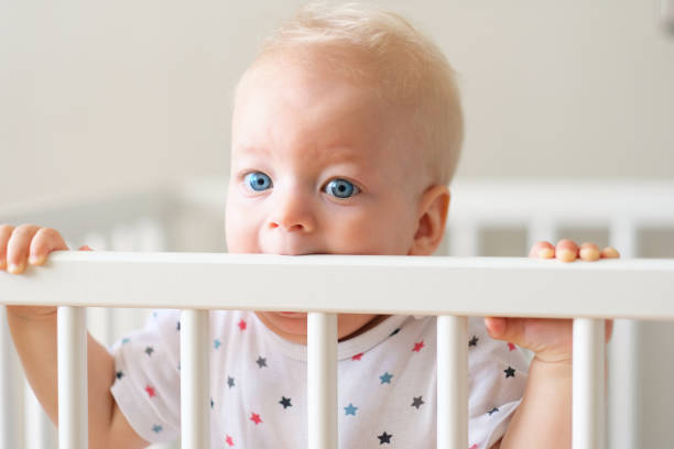 istock Baby boy standing in crib 961434900