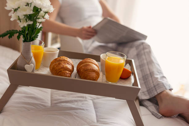 istock Woman reading newspapers and having breakfast 961439224