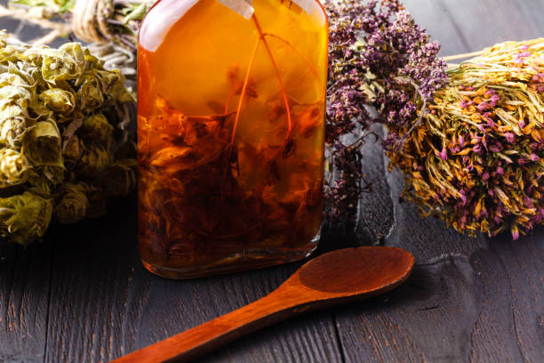 istock Bottles with herbs and oil on table 961446826