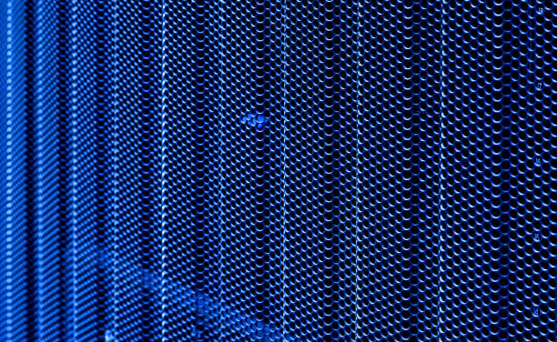 door perforated of server rack cabinet. the key is inserted into door lock. side lighting and shallow dof - network server rack computer black imagens e fotografias de stock