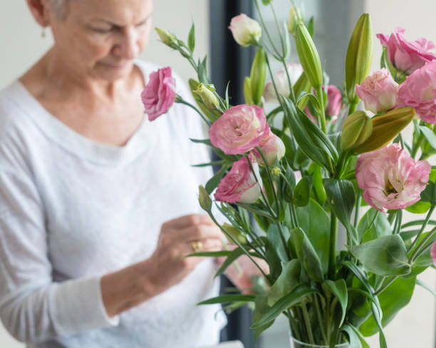 istock Senior Woman Standing By Flowers 961447618
