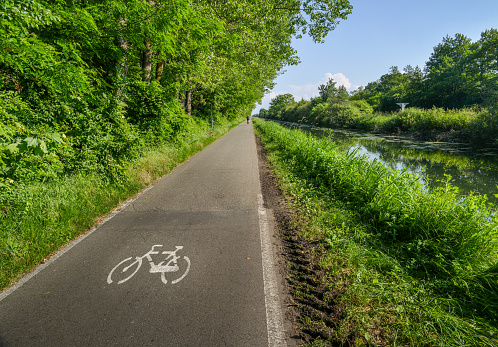 Empty cycling path along the Naviglio Pavese, canal which stretches for 30km from Pavia to Milan in Lombardy, northern Italy