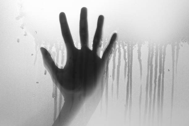 istock Shadow of hand the white frosted glass 961451594