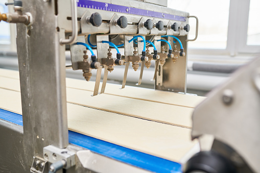 Cutting dough manufacturing machine