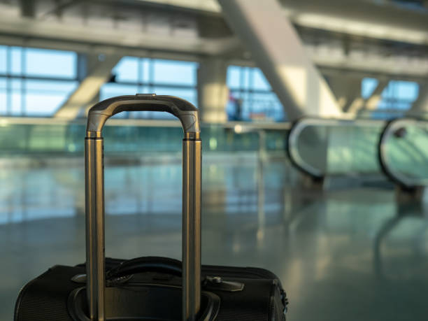 istock Carry on luggage sitting at empty modern airport 961456962