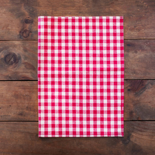 istock Red classic  Checkered table cloth on wooden table, background with copy space, close up 961456982