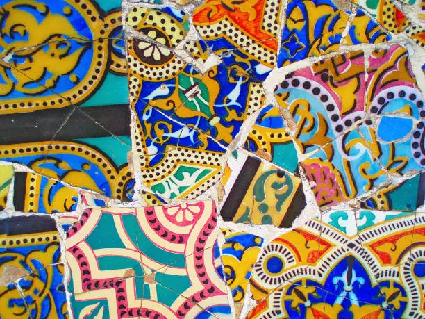 Photo of decoration in Park Guell, tile background broken glass mosaic,  Barcelona, Spain. Designed by Gaudi