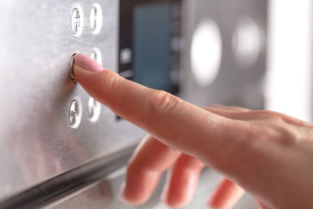 istock Detail of female hand while using the microwave 961466382