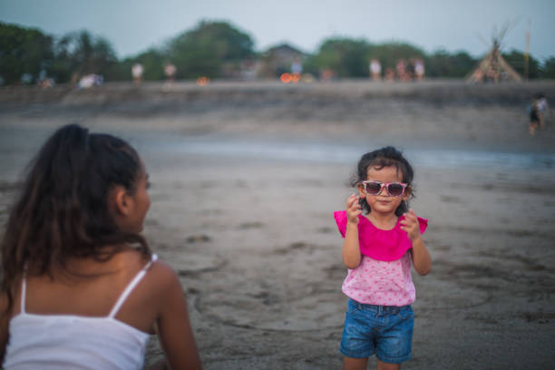 Two people, mother and daughter relaxing on the beach.