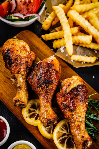 istock Fried chicken drumstics with French fries 961467504