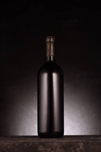 single bottle of luxury red wine on black