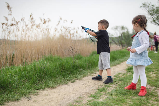 Brother and sister shooting from a toy gun