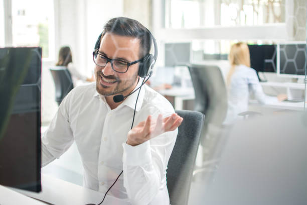 istock Happy businessman talking on headset in office 961477354