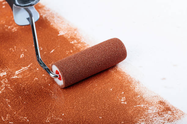 istock Painting roller  surface copper paint  inside in apartment close up. 961482188