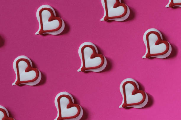 istock Candy heart (white)  on a pink paper  background.  Creative concept. Abstract photo. Template. 961482712
